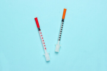 Two syringes on a black background. Vaccination. Top view