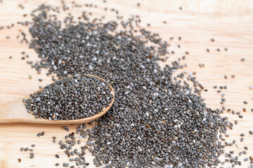 Healthy Chia seeds in a wooden spoon on the table close-up. horizontal