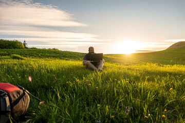 man working outdoors with laptop