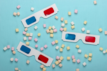 Anaglyph disposable paper 3d glasses with marshmallows on a blue background. Pop art, minimalism