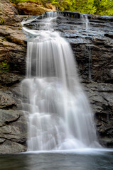 Obraz premium A flowing cascade of water at Laverty Falls in Fundy National Park, New Brunswick, Canada - travel destination