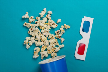 Movie time. Cardboard bucket of popcorn and Stereoscopic anaglyph disposable paper 3d glasses on...