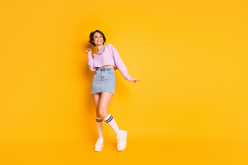 Full length body size view of her she nice-looking attractive lovely slender thin glad cheerful cheery girl dancing isolated on bright vivid shine vibrant yellow color background