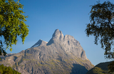 Romsdalshornet mountain, blue sky, summer time.