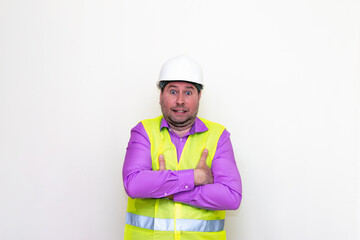 Curious crossed his arms about himself engineer makes all kinds of grimaces on a white background.