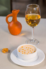 Walnut sauce in the bowl on the table with white wine, ready to eat.