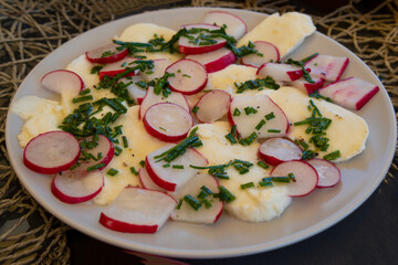mixed healthy salad with mozzarella cheese and
radish prepared to eat on a plate