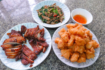 traditional Thai culture fried pork neck grilled intestines Chitterlings cuisine air fryer or moo tod ping yang box set street fast foods menu at thailand hot spicy sauces on wood sticky rice