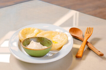 Potatoes dumpling with souse on the plate , ready to eat.