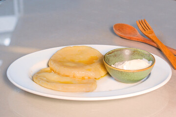Potatoes dumpling with souse on the plate , ready to eat.