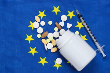 Syringe and pills with euro union flag. Vaccination, medicine