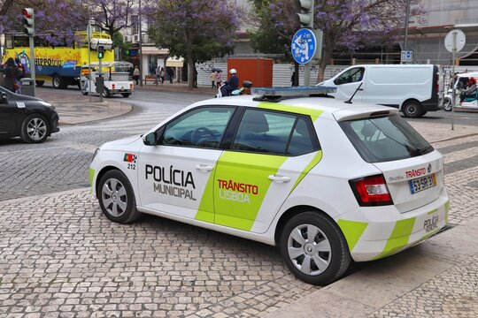 LISBON, PORTUGAL - JUNE 4, 2018: People walk by Skoda Fabia car of Municipal Police in Lisbon, Portugal. Lisbon is the 11th-most populous urban area in the EU (2.8 million people).
