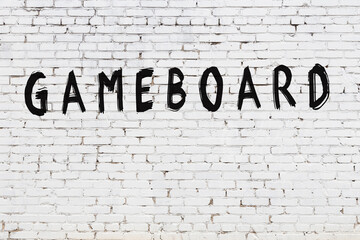 Word gameboard painted on white brick wall