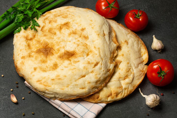 Fresh homemade pita with tomatoes and spices. Cooking concept