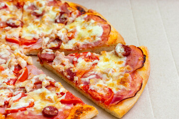 Italian pizza with cheese and bacon in cardboard delivery box. Fast food concept. Food background texture. copy space