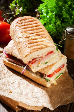 Toasted panini with ham, cheese and arugula sandwich