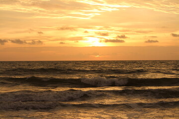 A beautiful sunset . The sun throwing its reds and oranges into the sky like a molten lava.