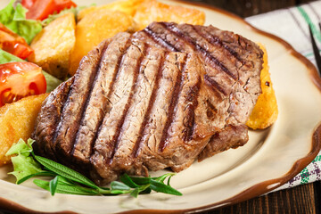 Succulent portions of grilled fillet mignon served with baked potatoes