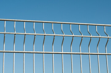 a simple zinc plated fence in sunlight