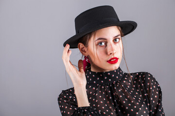 Fototapeta na wymiar Portrait of a young model in polka dot dress, studio indoor