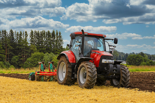 Case IH Tractor and Plow Working on Field.  Illustrative Editorial Content. 