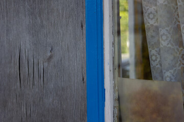 old wooden door with blue shutters