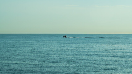 Fototapeta na wymiar motor boat racing on the blue sea