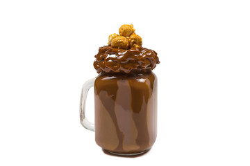 Chocolate milkshake with whipped cream, cookies, waffles, served in glass mason jar. 
