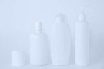 Obraz na płótnie Canvas White plastic bottles with cosmetics on white background.