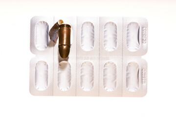Obraz premium medicines and bullets on white background 