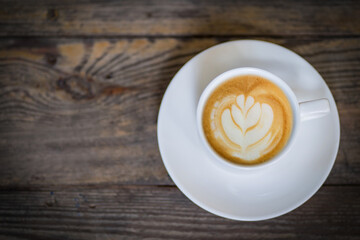 latte art coffee or cappuccino on wooden table background
