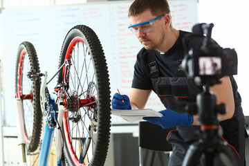 Handsome bearded male person making notes during work