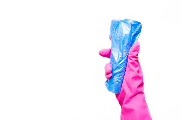 Garbage bag. Female hand in a pink glove holds a bundle of garbage bag on a white background. Garbage bag in hand and gloves