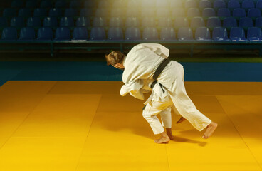 Martial arts. Sparing Portners. Sport man and woman in white kimono train judo throws and captures...