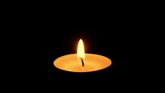 Prayer Candle Is Lit In The Dark And Goes Out