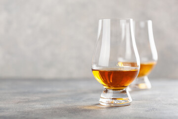glass of whisky spirit brandy on gray concrete background