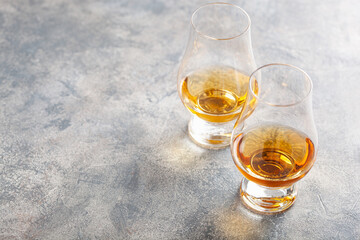 glass of whisky spirit brandy on gray concrete background