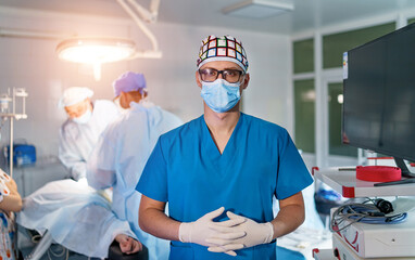 Portrait of the professional surgeon. Doctor wearing mask. Medicinal standng in operation theatre...