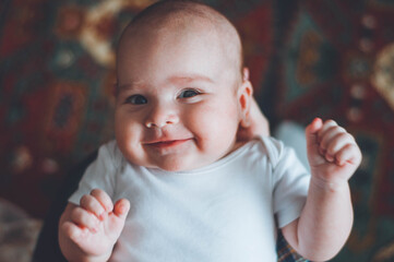 portrait of a little boy. cute baby. three month old boy smiling. baby with a pacifier