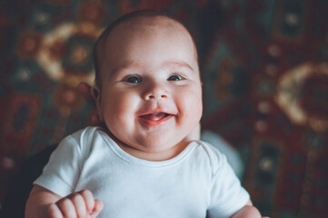 portrait of a little boy. cute baby. three month old boy smiling. baby with a pacifier
