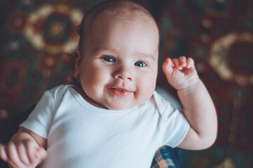 portrait of a little boy. cute baby. three month old boy smiling. baby with a pacifier