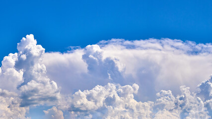 Light through cumulus clouds against the backdrop of an exciting, vibrant sky. panorama, natural composition