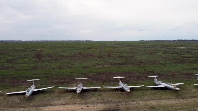 A row of abandoned military aircraft. Retired military base for storing aircraft