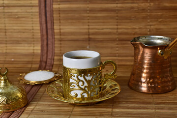 gold cup for coffee on a light background