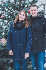 winter love story. husband and wife near the snow-covered Christmas tree. New Year's mood