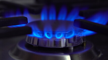 The gas burner on the stove burns. The flame is blue.
