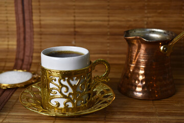 gold cup for coffee on a light background