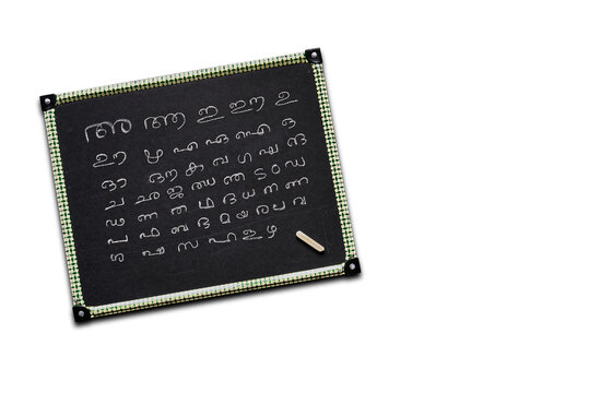 Incomplete Malayalam alphabets written on a kid's slate board isolated on white background.