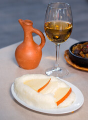 Georgian traditional food ghomi with cheese, wine and kuchmachi.