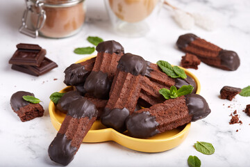 Chocolate cookies in a shape of stripes, covered with chocolate. Delicious homemade dessert. 